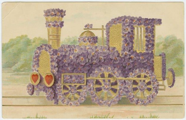Train engine covered in flowers.