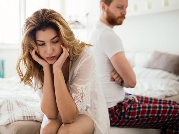 unhappy couple in bed