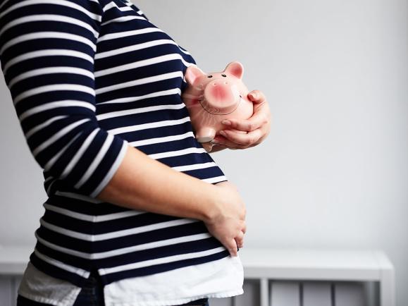 Pregnant mother with piggy bank